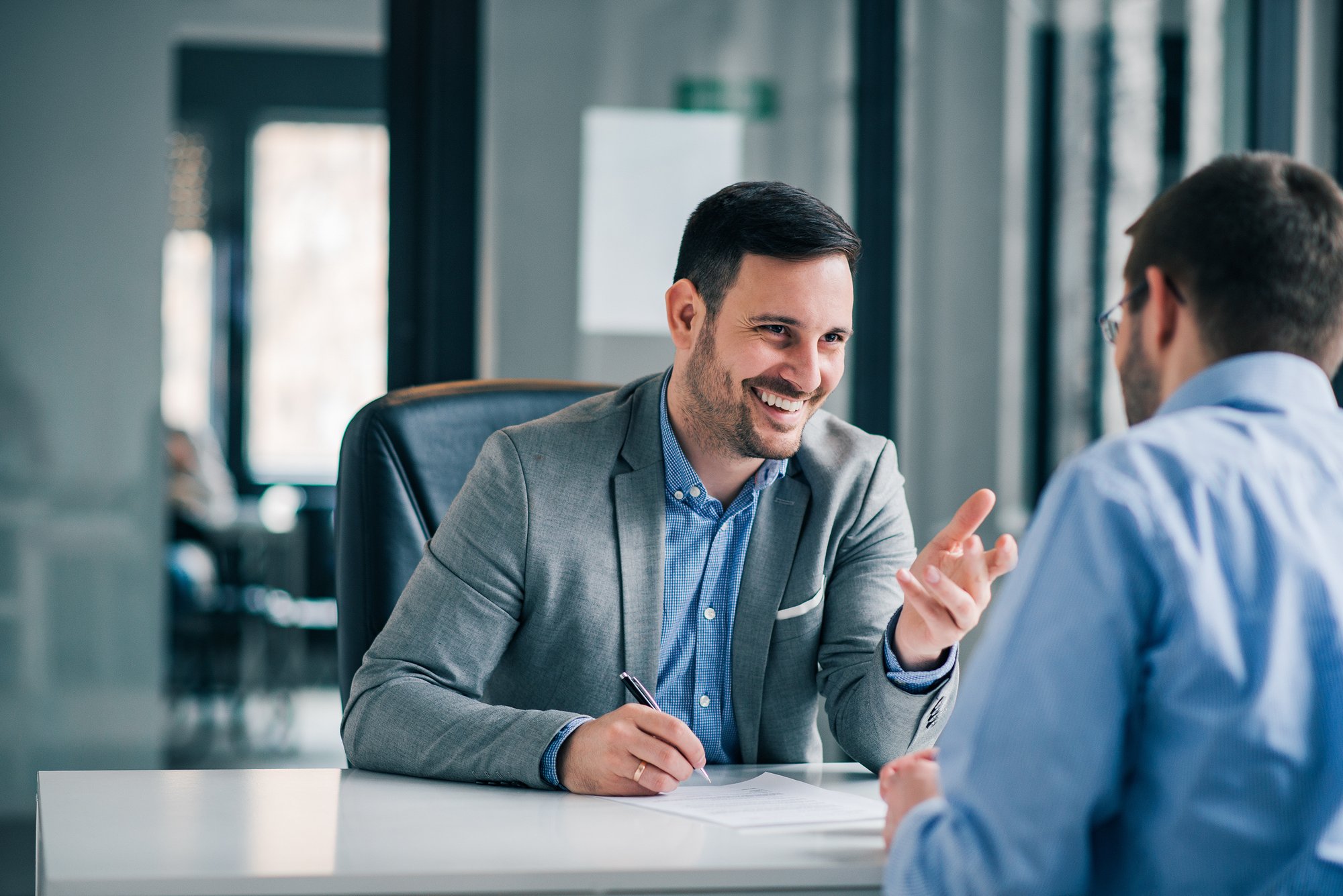 man-leaning-forward-business-deal