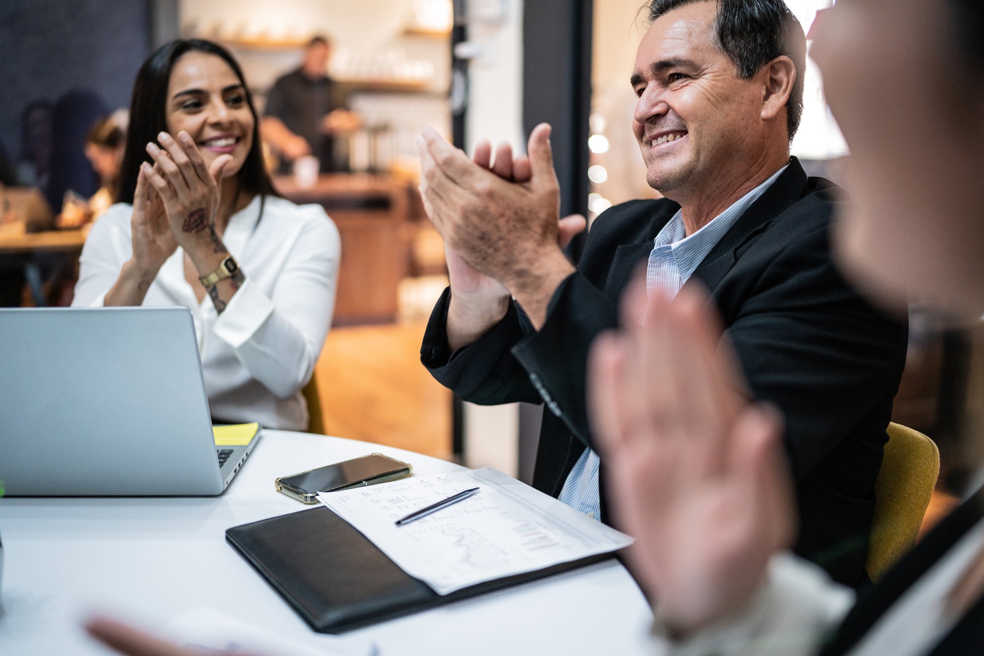 people-clapping-at-business-table